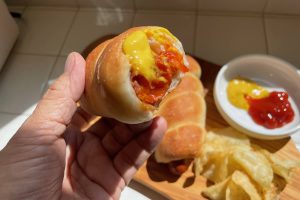 hot dog bite with ketchup and mustard
