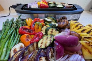 closeup of veggies in front of grill