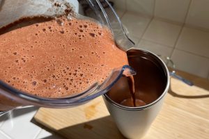 chocolate banana shake pouring into cup