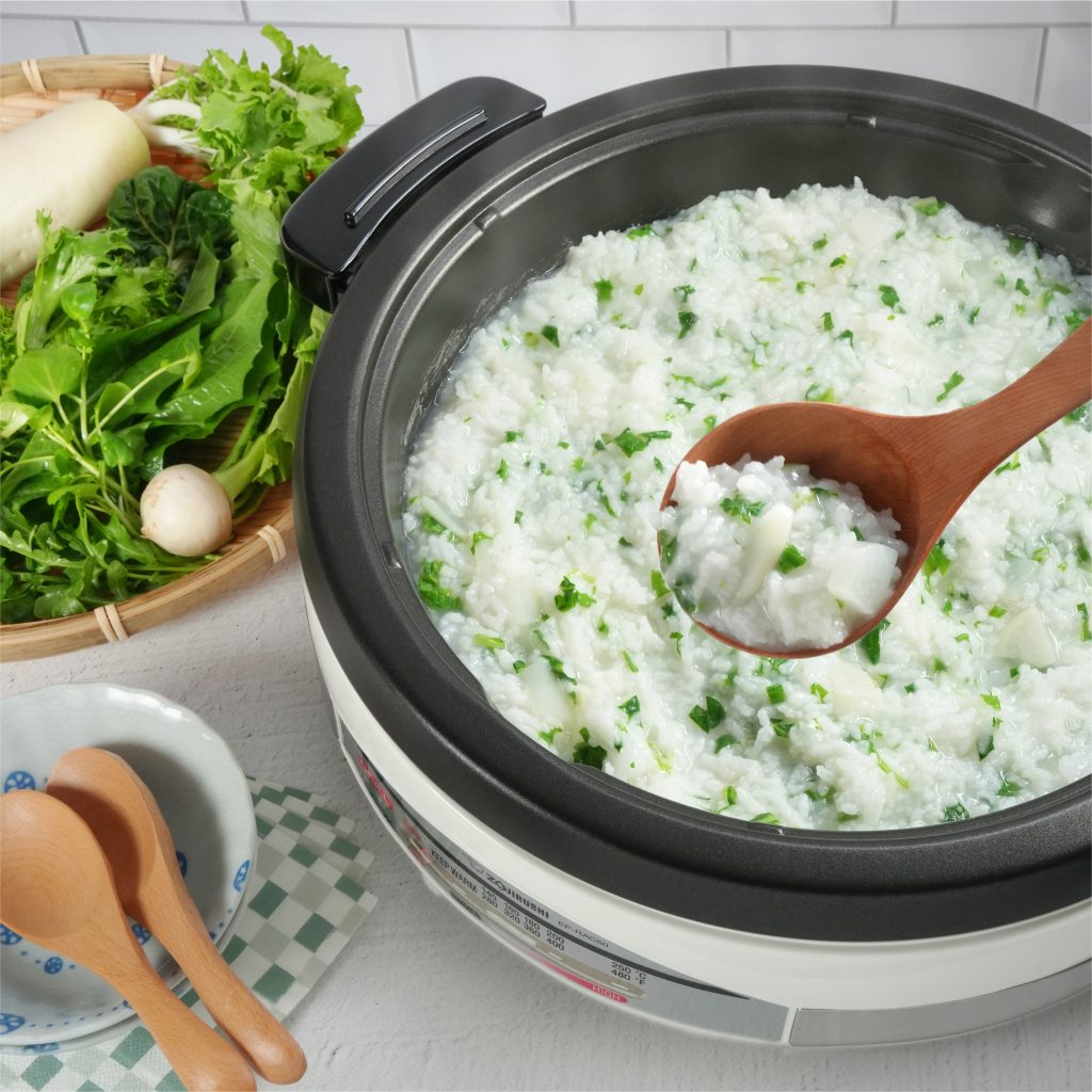 Seven-Herb porridge in the electric skillet next to the bowl of 7 herbs