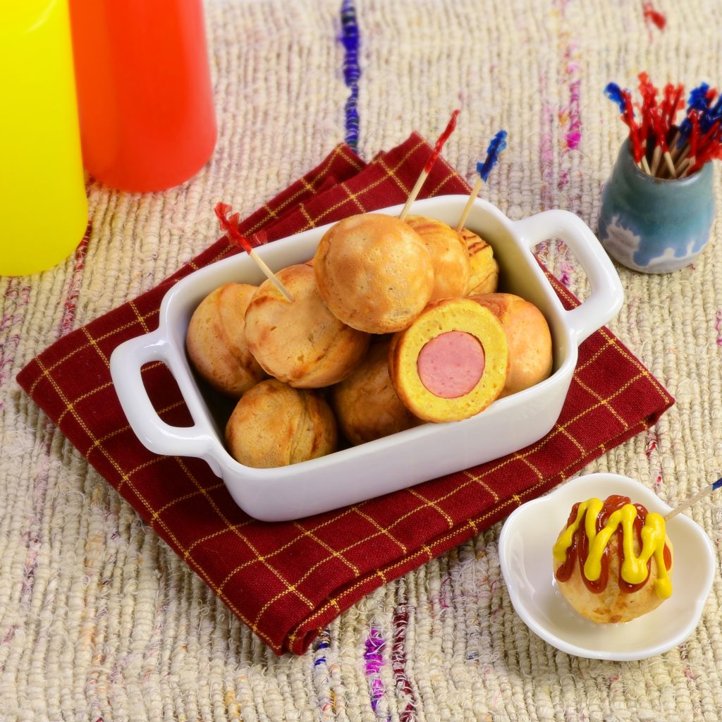 Round corn dog in a white plate