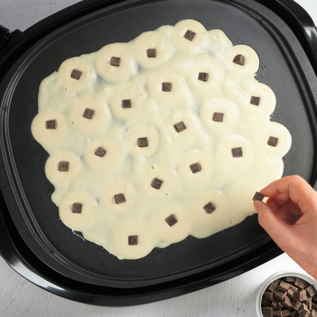 putting waffle ingredients in the takoyaki plate